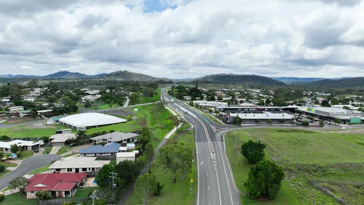Upgrade of a 4-way intersection on Dawson Highway with machinery, safety barriers, and workers on site.