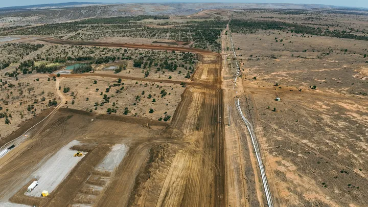 An expansive view of a civil project site featuring road construction and infrastructure development in a remote area, emphasising efficient land management and planning