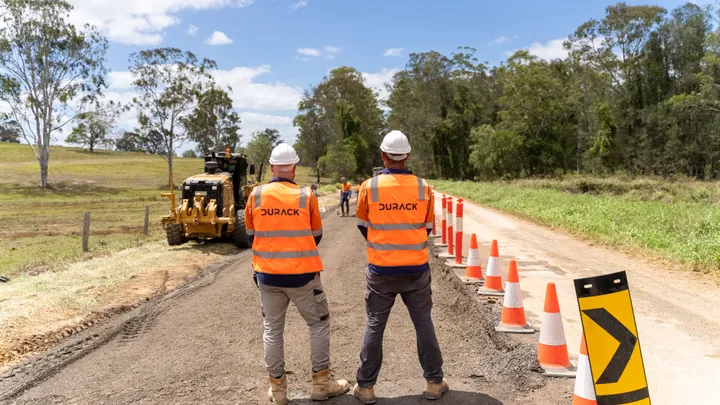 Durack Civil team using a grader to level the road base on Clermont Alpha Road for paving and sealing.