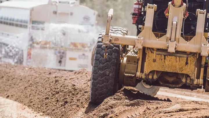 Heavy machinery grading dirt during the HSC 1938 DFRA Roads Restoration Works by Durack Civil for Hinchinbrook Shire Council.