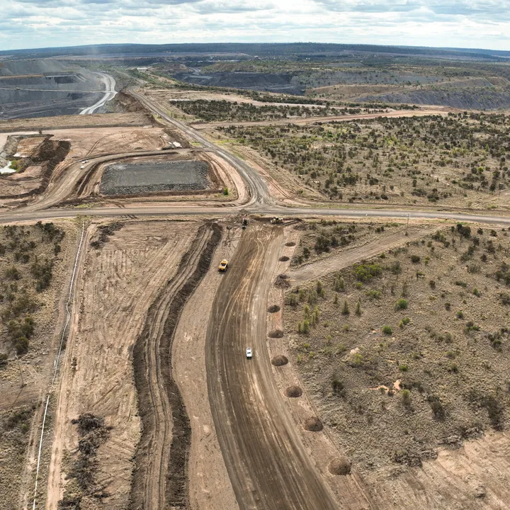 Aerial perspective of road formation and site preparation for mining infrastructure,